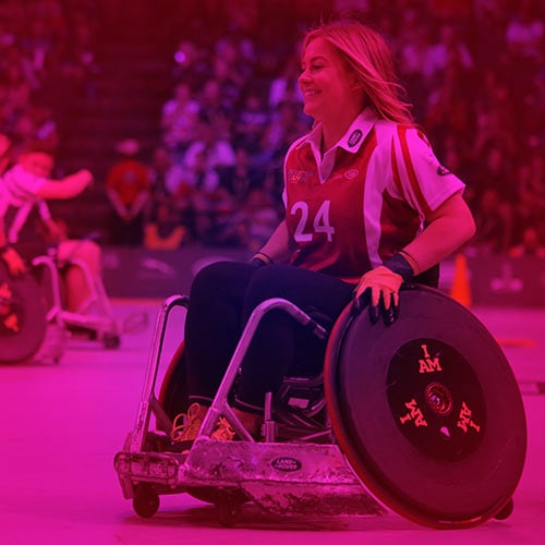 Woman in a wheelchair playing a sport